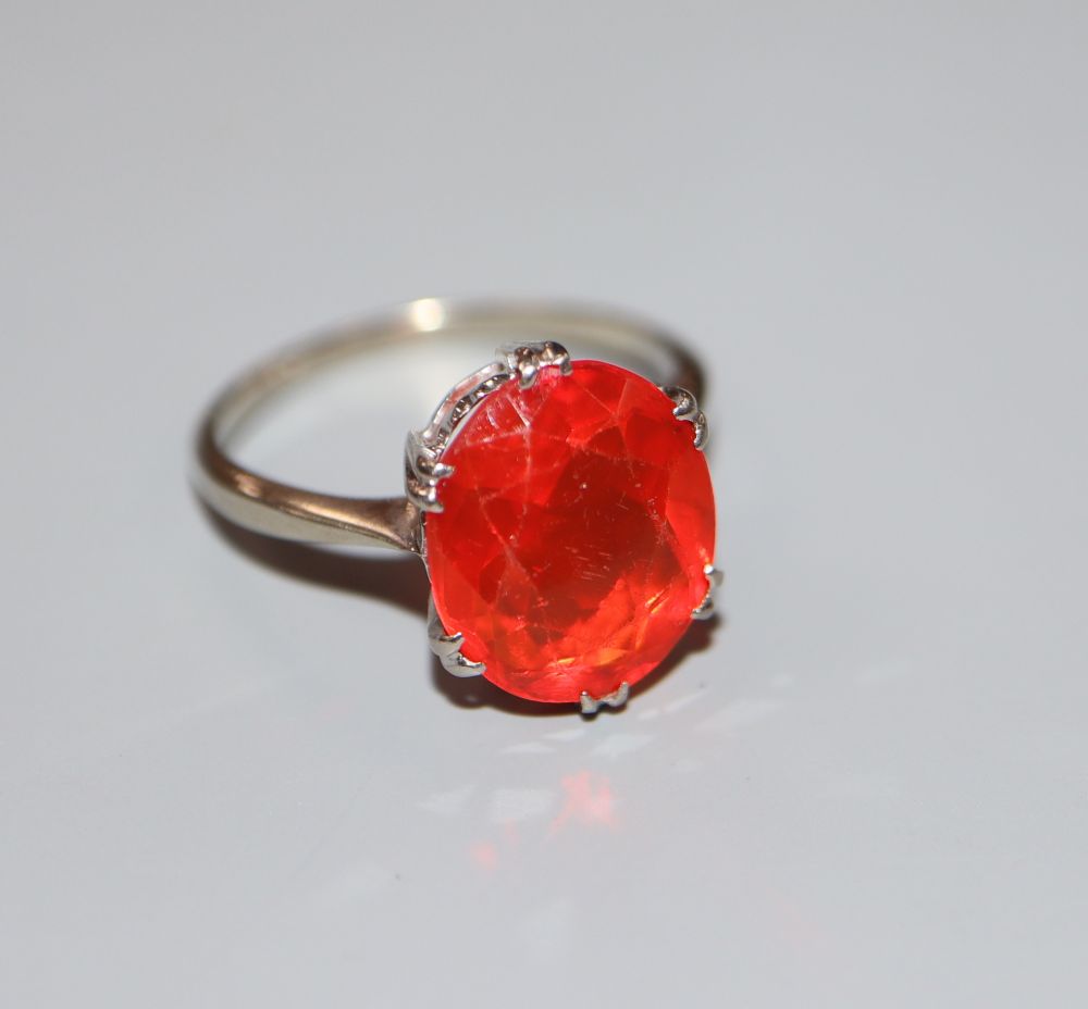 A 9ct white metal and oval cut fire opal? set dress ring, size N, gross 2.9 grams.